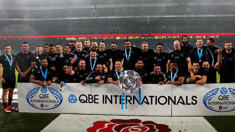 The New Zealand team pose with the trophy after the QBE International match between England and New Zealand at Twickenham