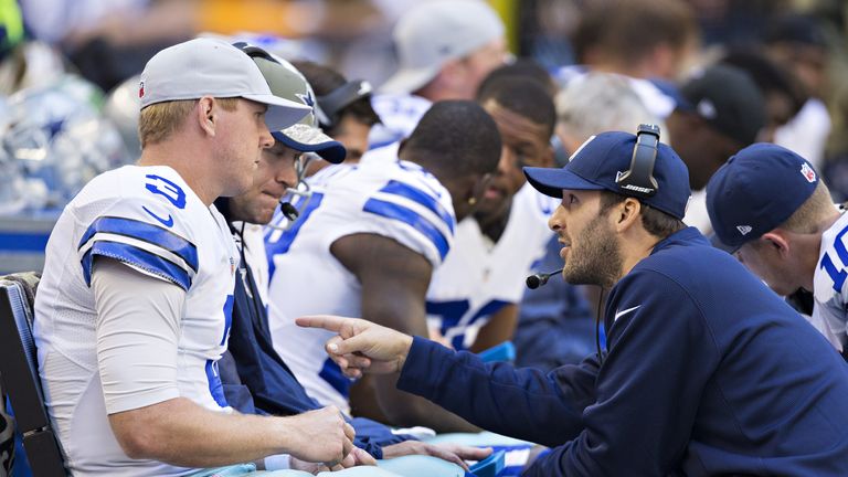 Tony Romo (right) talks with fellow quarterback Brandon Weeden of the Dallas Cowboys on the sidelines 