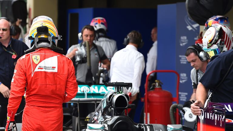 Fernando Alonso checks out Lewis Hamilton's Mercedes