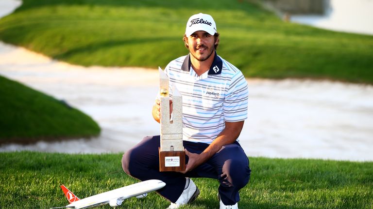 Brooks Koepka poses with the trophy 