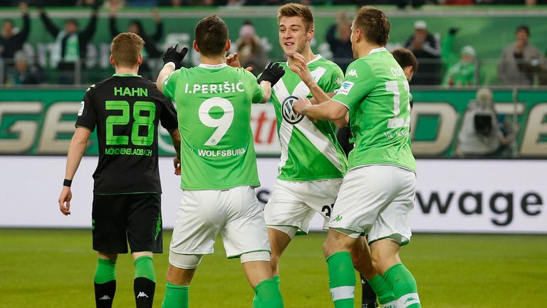 The team of Wolfsburg celebrates after Robin Knoche (L) scores his team's first goal
