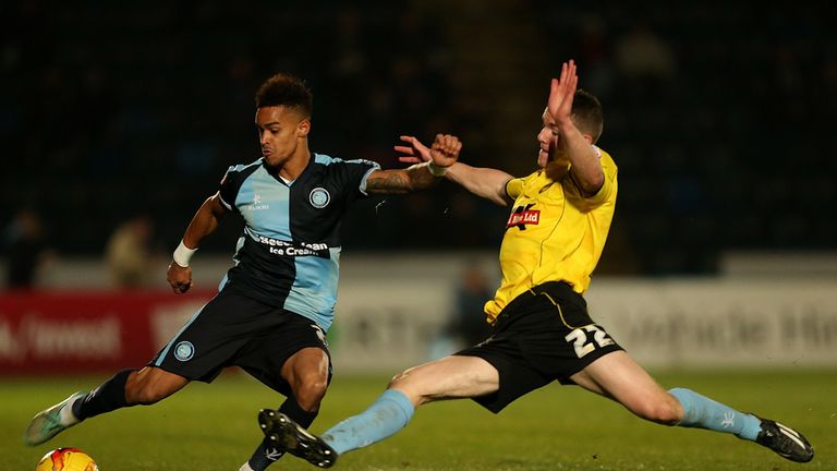 Paris Cowan-Hall of Wycombe is tackled by Darragh Lenihan of Burton 