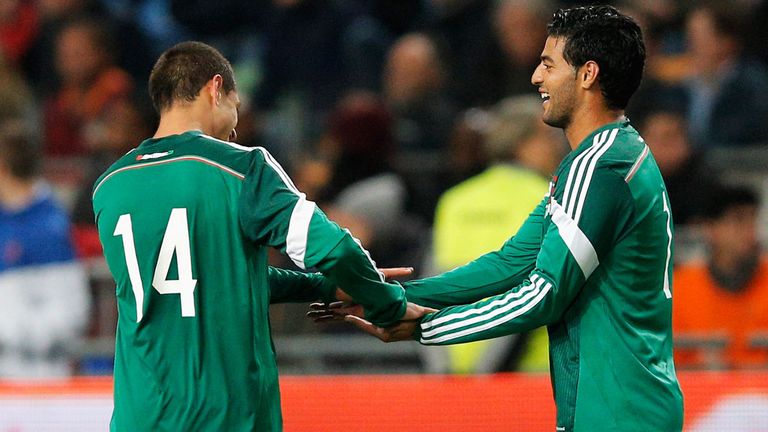 Carlos Vela: Celebrates with fellow Mexico scorer Javier Hernandez 