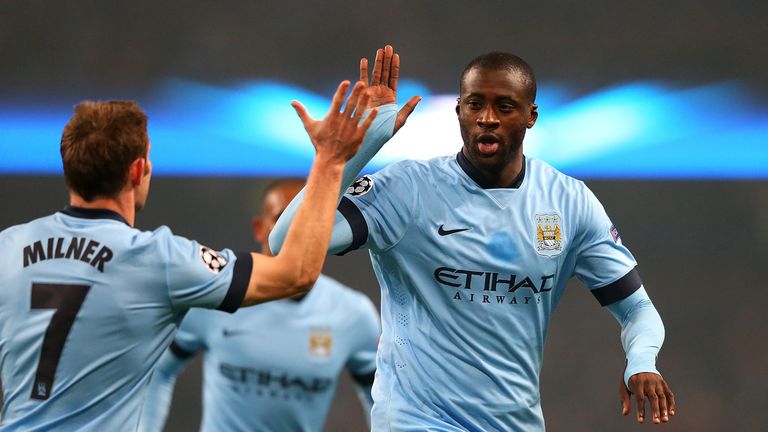Yaya Toure of Manchester City celebrates scoring his team's first goal with James Milner