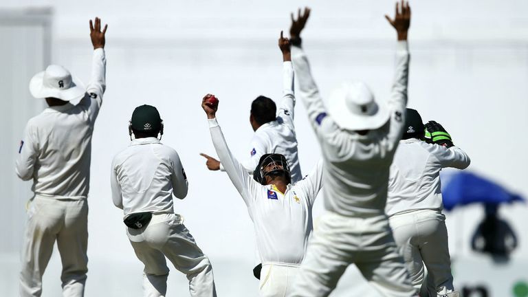 Azhar Ali celebrates after taking a catch to dismiss Nathan Lyon off the bowling of Zulfiqar Babar of Pakistan to claim victory