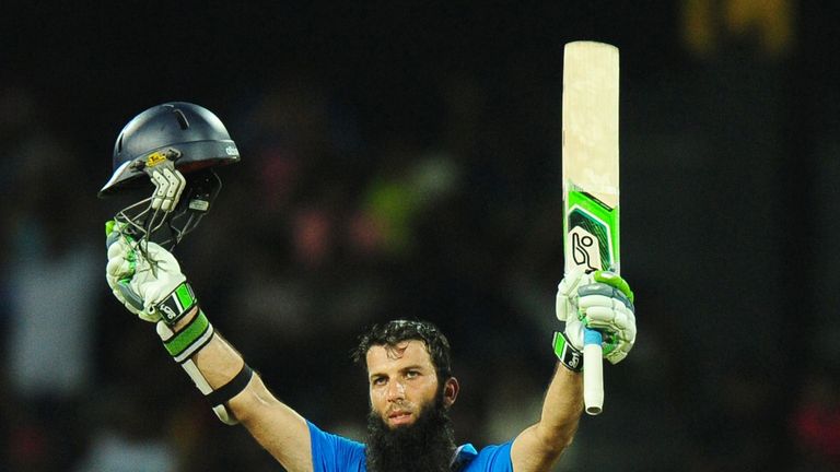 Moeen Ali raises his bat and helmet after reaching his century in the first ODI.