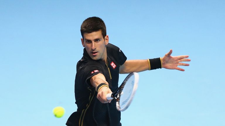 Novak Djokovic of Serbia plays a backhand against Marin Cilic of Croatia in their round robin match during the Barclays ATP