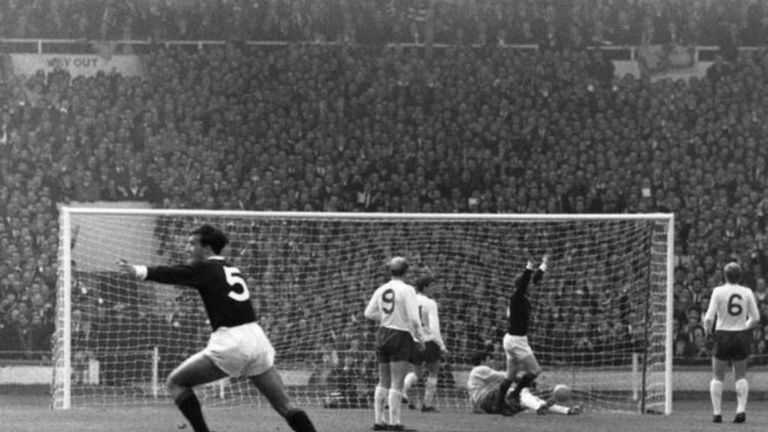 Denis Law celebrates with his arms aloft after scoring for Scotland against England at Wembley in 1967