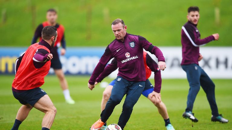 BURTON-UPON-TRENT, ENGLAND - NOVEMBER 11:  Wayne Rooney and Jack Wilshere in action during an England training session.