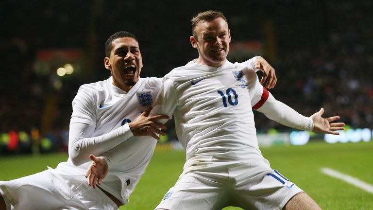 England striker Wayne Rooney (R) celebrates scoring their second goal with England's defender Chris Smalling (L) during the friendly at Scotland
