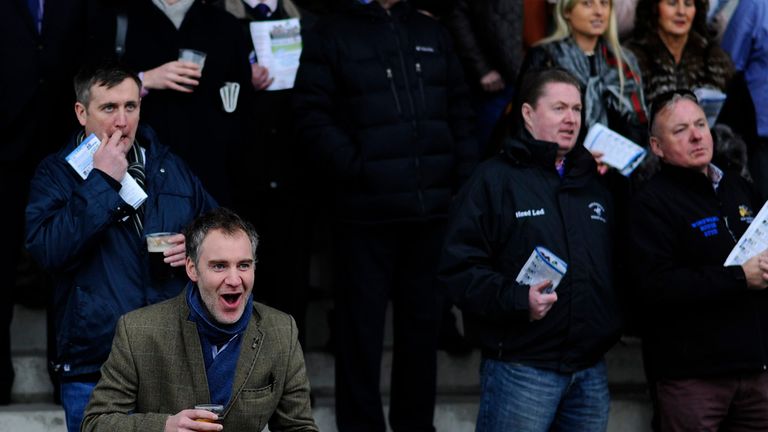 RATOATH, IRELAND - NOVEMBER 30: A racegoer reacts as he watches the action on the big screen at Fairyhouse racecourse on November 30, 2014.