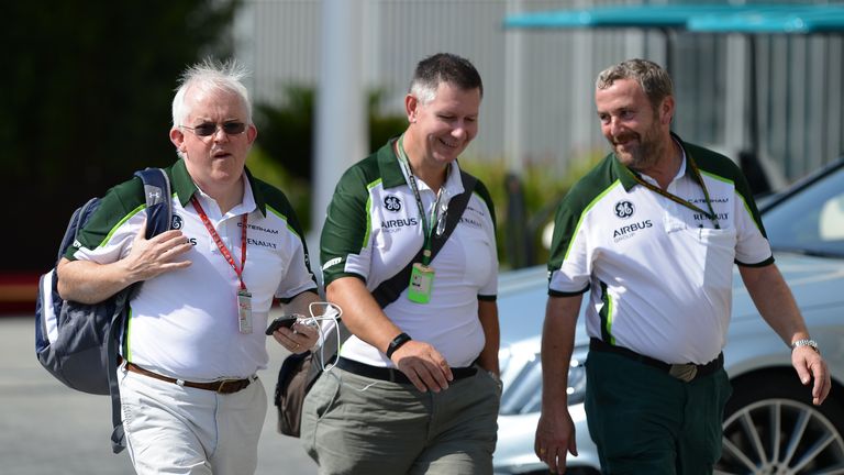 Caterham administrator and interim team boss Finbarr O¿Connell (L) makes his way into the Abu Dhabi paddock