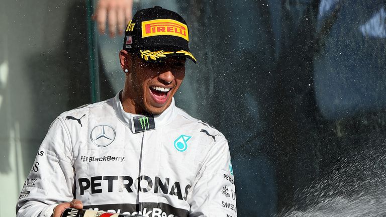 Lewis Hamilton celebrates on the podium