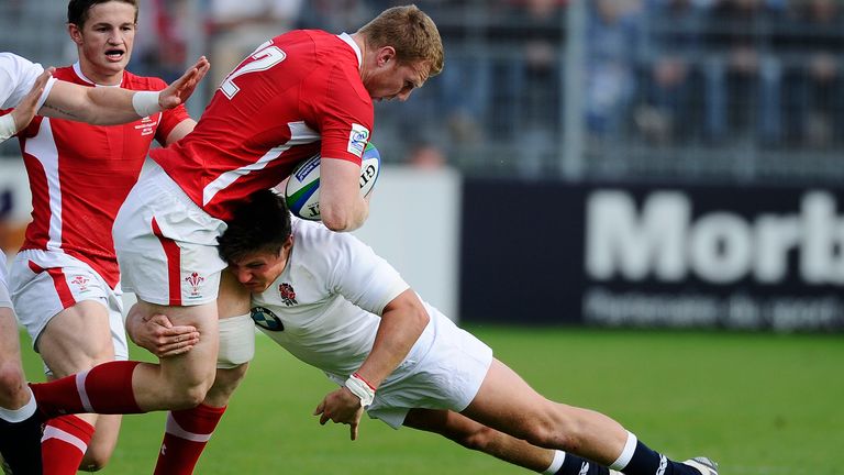 Wales centre Jack Dixon is tackled by England centre Harry Sloan during the IRB Junior World Championships