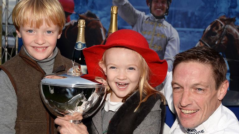 DONCASTER, ENGLAND - NOVEMBER 08:  Champion jockey Richard Hughes poses for photographs with his children Phoebe and Harvey after recieving his trophy  Don