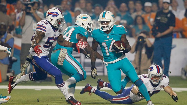 Jarvis Landry #14 of the Miami Dolphins is pursued by Nigel Bradham #53 of the Buffalo Bills