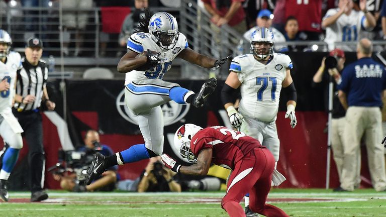 Running back Joique Bell of the Detroit Lions jumps over free safety Rashad Johnson of the Arizona Cardinals