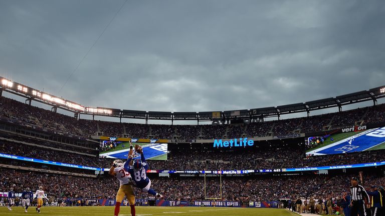 Larry Donnell of the New York Giants fails to make a catch against  Eric Reid of the San Francisco 49ers