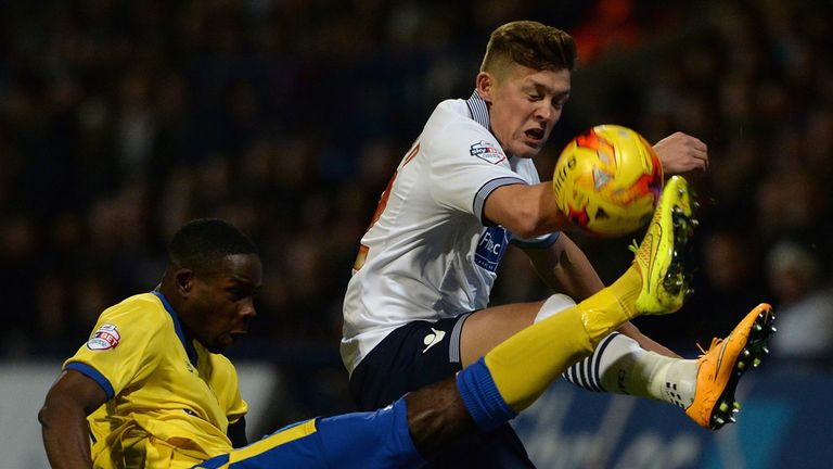 BOLTON, ENGLAND - NOVEMBER 07:  Max Clayton of Bolton Wanderers is tackled by Leon Barnett of Wigan Athletic during the Sky Bet Championship match between 