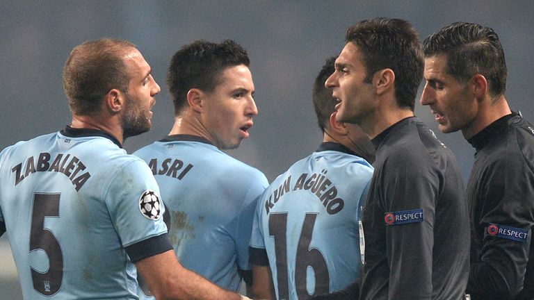 Manchester City players complain to referee Anastasios Sidiropoulos (centre) after the UEFA Champions League Group E match at the Etihad Stadium