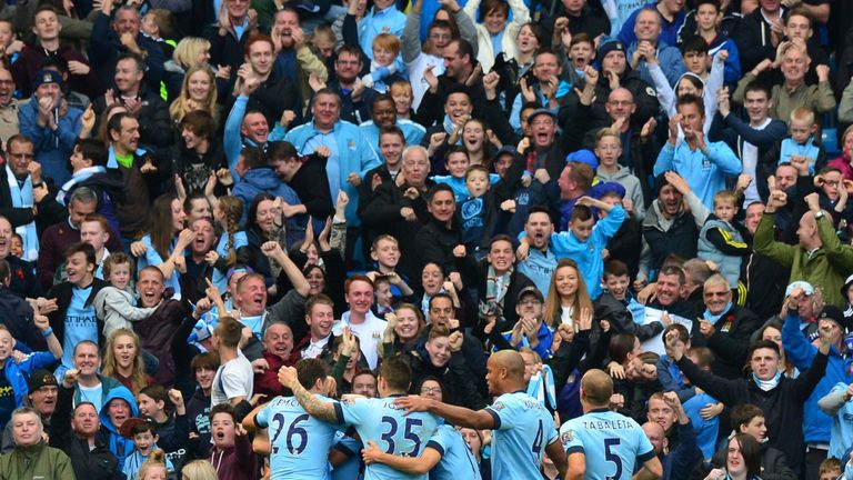 Manchester City players celebrate with the crowd after Sergio Aguero's  opener