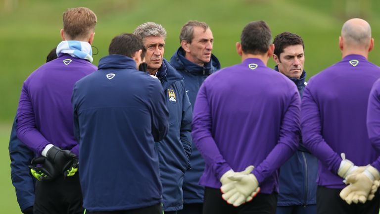 Manuel Pellegrini addresses his Manchester City players at an open training session ahead of Bayern Munich game