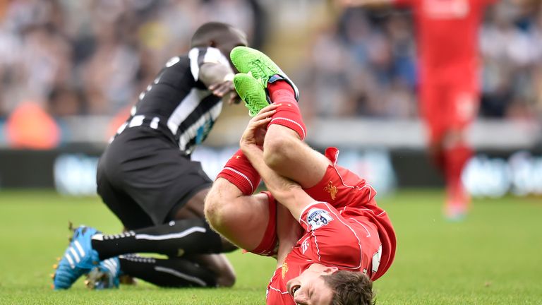Liverpool's Joe Allen (front) is tackled by Newcastle United's Moussa Sissoko during the Barclays Premier League match at St. James' Park, Newcastle