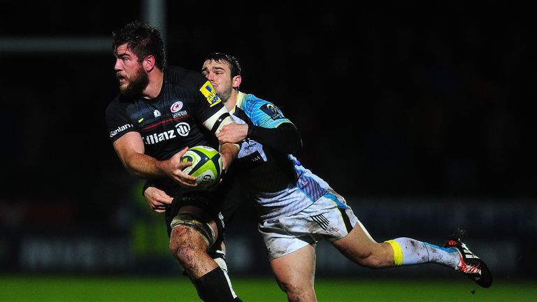 NEATH, WALES - NOVEMBER 07:  Nick de Jaeger of Saracens is tackled by Tom Habberfield of Ospreys during the LV= Cup match between Ospreys and Saracens at T