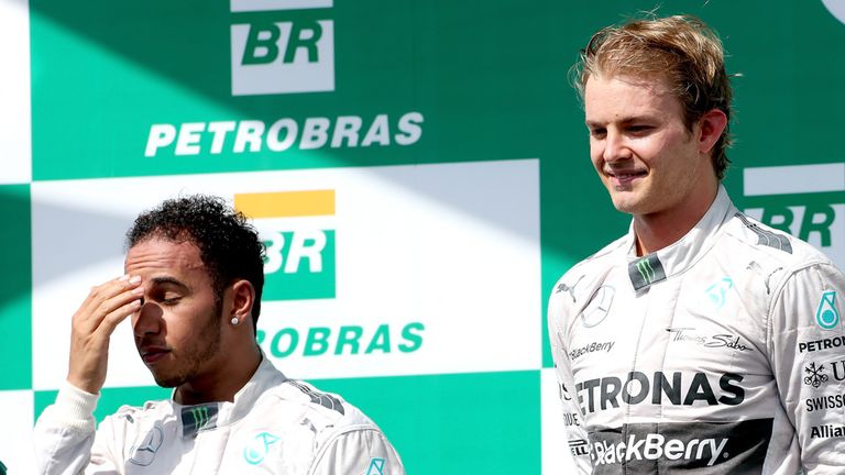 Nico Rosberg celebrates next to Lewis Hamilton
