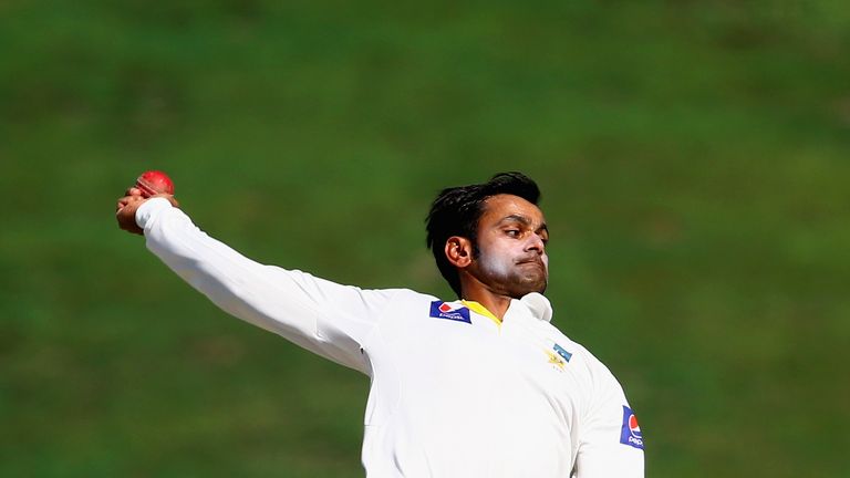 ABU DHABI, UNITED ARAB EMIRATES - NOVEMBER 11: Mohammad Hafeez of Pakistan bowls during Day Three of the First Test between Pakistan and New Zealand at She