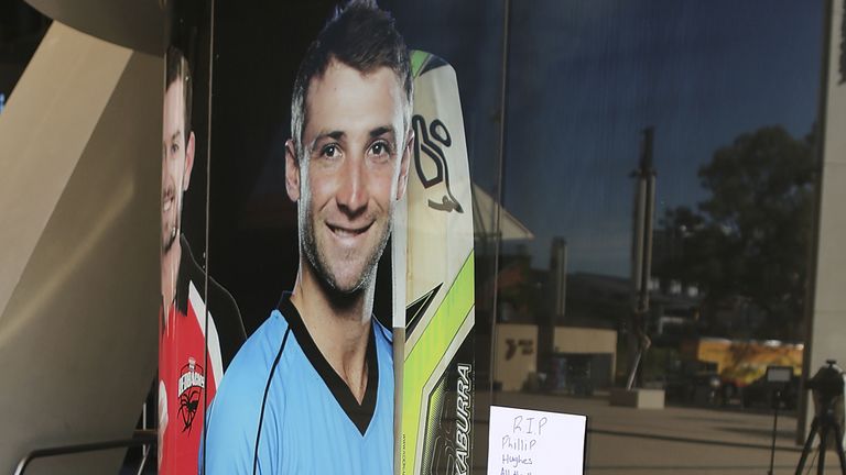 ADELAIDE, AUSTRALIA - NOVEMBER 28:  Tributes are seen lying next to a photograph of Phil Hughes outside the Adelaide Oval on November 28, 2014 in Adelaide,
