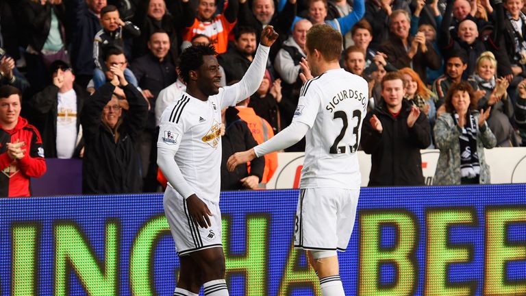 Wilfried Bony of Swansea City celebrates with Gylfi Sigurdsson as he scores their first goal