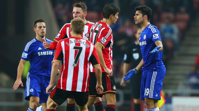 Diego Costa of Chelsea clashes with Santiago Vergini of Sunderland