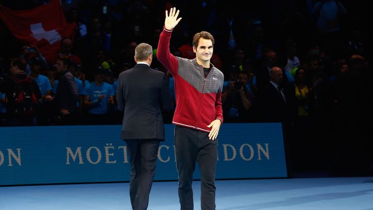 Roger Federer of Switzerland waves after announcing decision to withdraw from singles final against Novak Djokovic at ATP World Tour Finals at O2 Arena