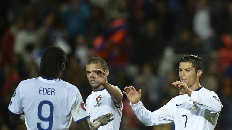 Portugal's defender Pepe (C), Portugal's forward Cristiano Ronaldo (R) and Portugal's forward Eder celebrate their 1-0 victory over Armenia