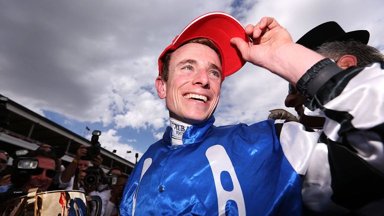 Jockey Ryan Moore celebrates with the trophy after winning on Protectionist in race seven at the Emirates Melbourne Cup