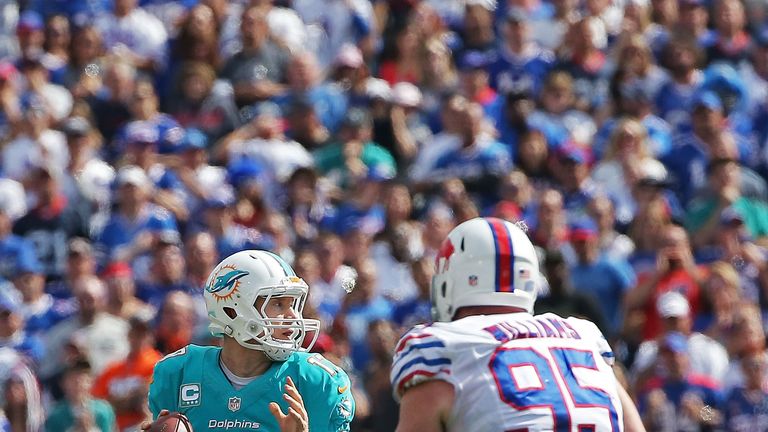 Ryan Tannehill of the Miami Dolphins is rushed by Kyle Williams of the Buffalo Bills