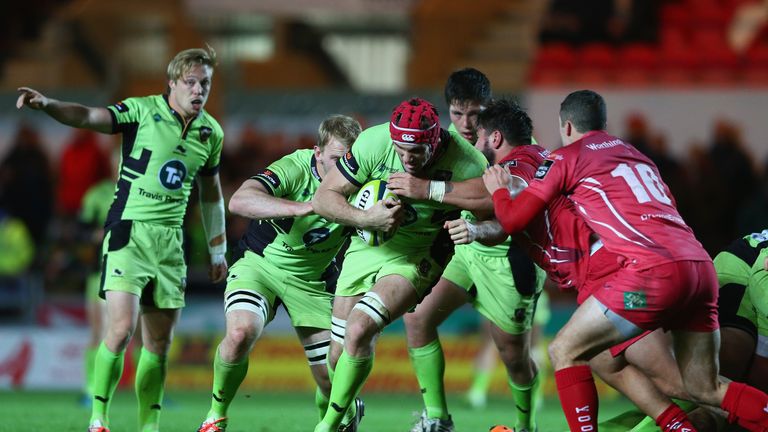 LLANELLI, WALES - NOVEMBER 07: Christian Day (3L) of Northampton Saints is held up by Rory Pitman (2R) of Scarlets during the LV=Cup match between Scarlets