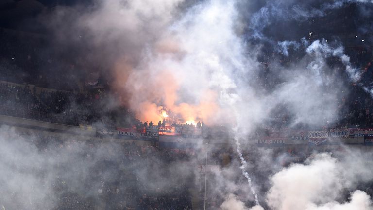 Flares are thrown on the pitch at the San Siro