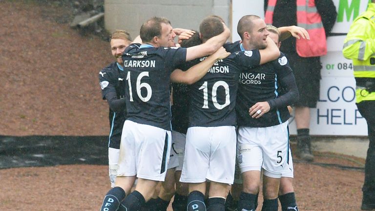 Dundee's Thomas Konrad (hidden) is crowded by team-mates