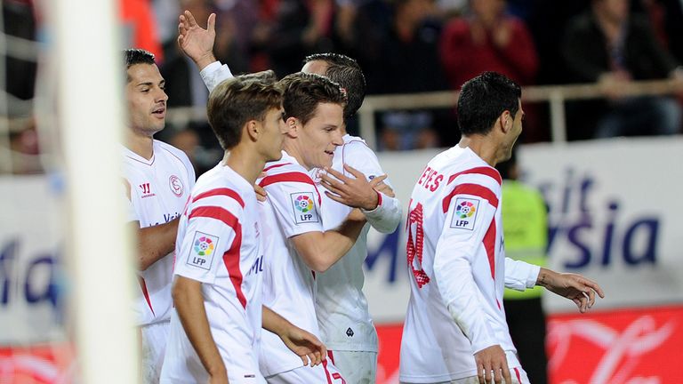 Sevilla's French forward Kevin Gameiro (C) celebrates with his teammates after scoring during the Spanish league football match Sevilla FC vs Granada FC