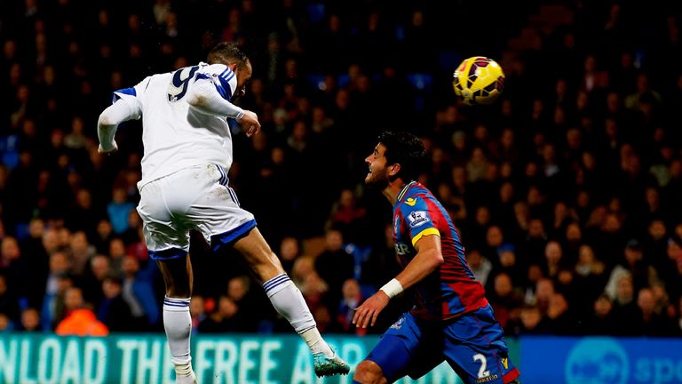 Steven Fletcher of Sunderland scores the opening goal as Joel Ward of Crystal Palace closes in during their Premier League game at Selhurst Park