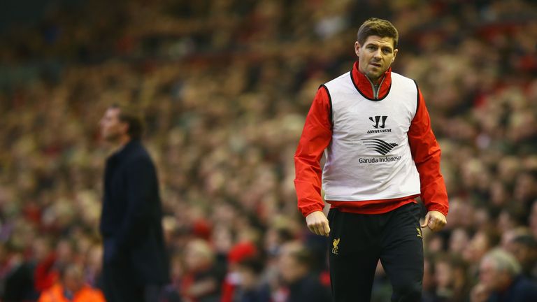 Substitute Steven Gerrard warms up as Brendan Rodgers stalks the touchline