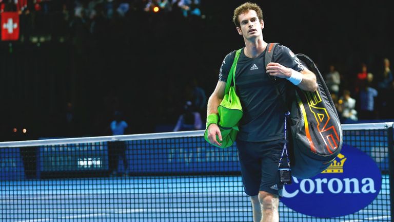 Andy Murray leaves the court after defeat in the round robin singles match against Roger Federer