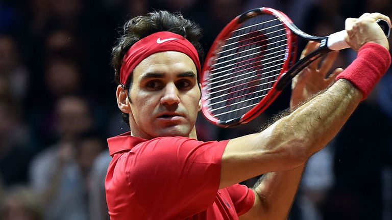 Roger Federer returns the ball to Richard Gasquet during the Davis Cup final between France and Switzerland