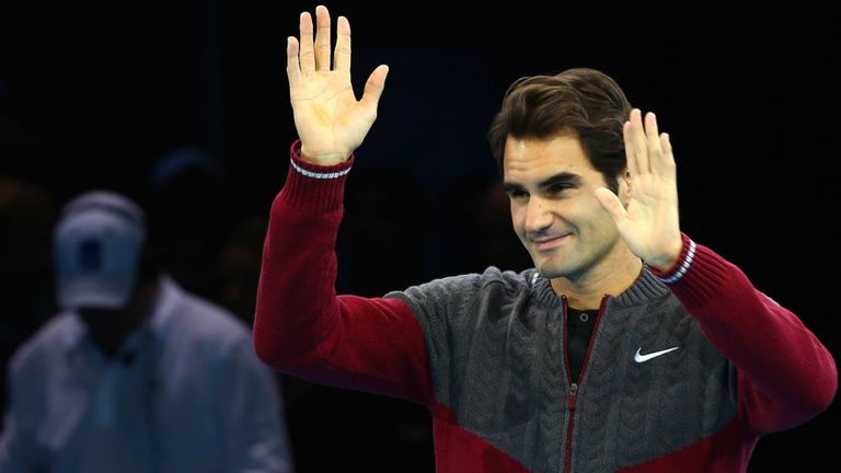 Roger Federer waves after announcing his decision to withdraw from the final against Novak Djokovic