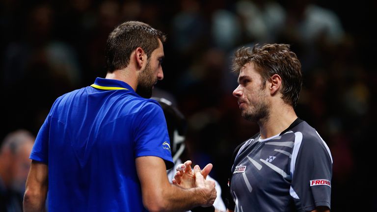 Marin Cilic shakes hands with Stan Wawrinka after the round robin singles match on day six of the ATP World Tour Finals