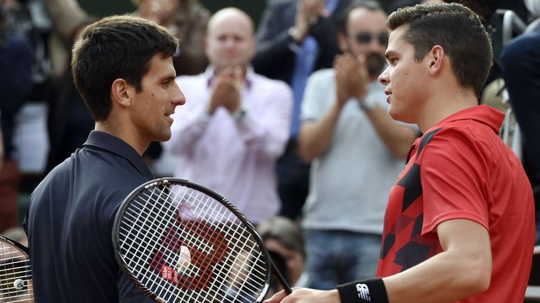 Novak Djokovic shakes hands with Milos Raonic at the end of their French Open quarter-final