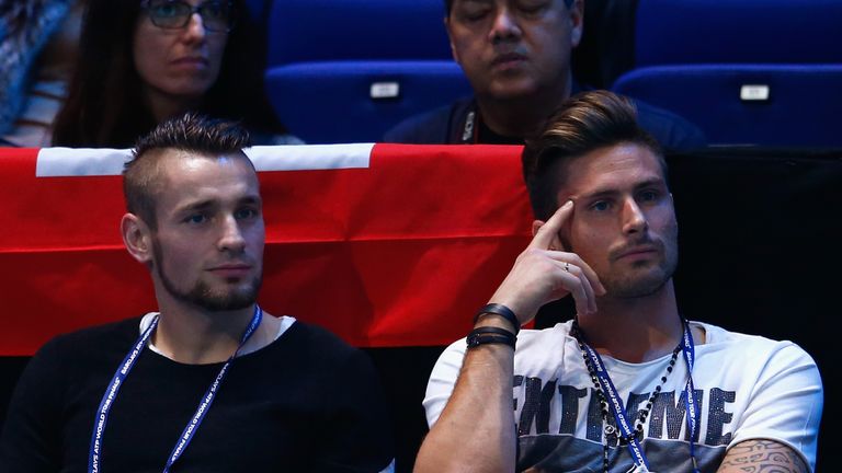 Mathieu Debuchy and Olivier Giroud of Arsenal watch Novak Djokovic of Serbia compete at the ATP World Tour Finals in London