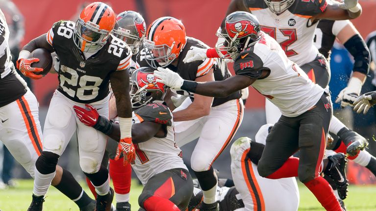 Running back Terrance West of the Cleveland Browns is tackled by Tampa Bay Buccaneers
